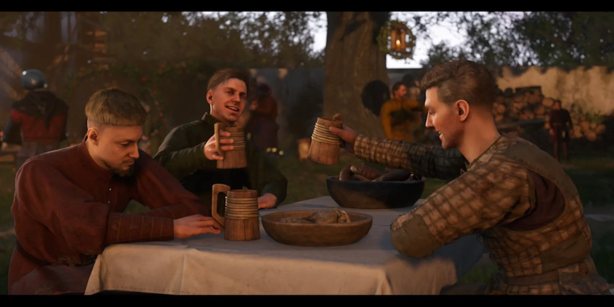 Các nhân vật đang ăn uống và trò chuyện vui vẻ trong một quán rượu thời trung cổ của Kingdom Come Deliverance 2