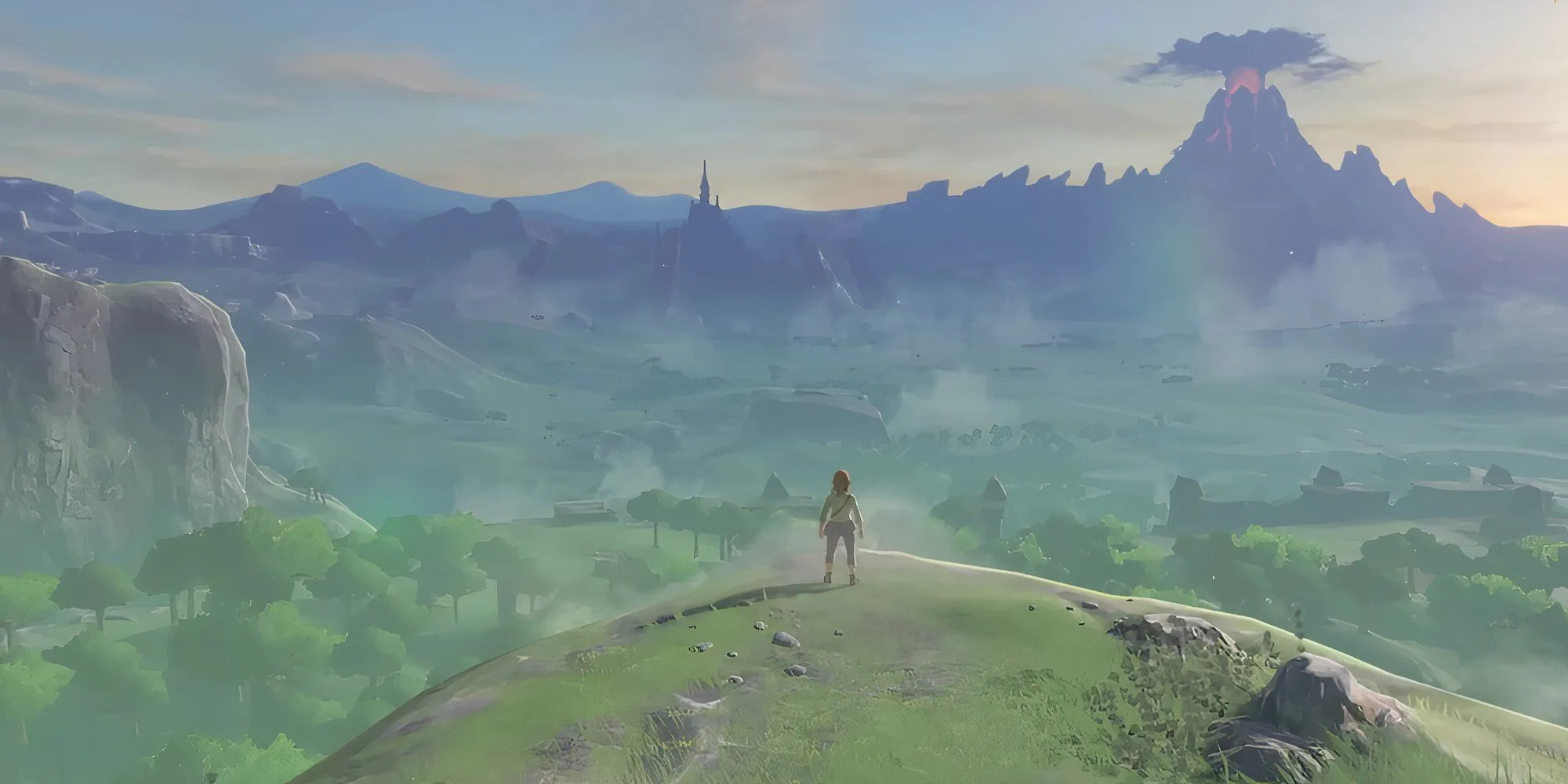 Link đứng trên một vách đá nhìn ra phong cảnh rộng lớn của Hyrule trong The Legend of Zelda: Breath of the Wild