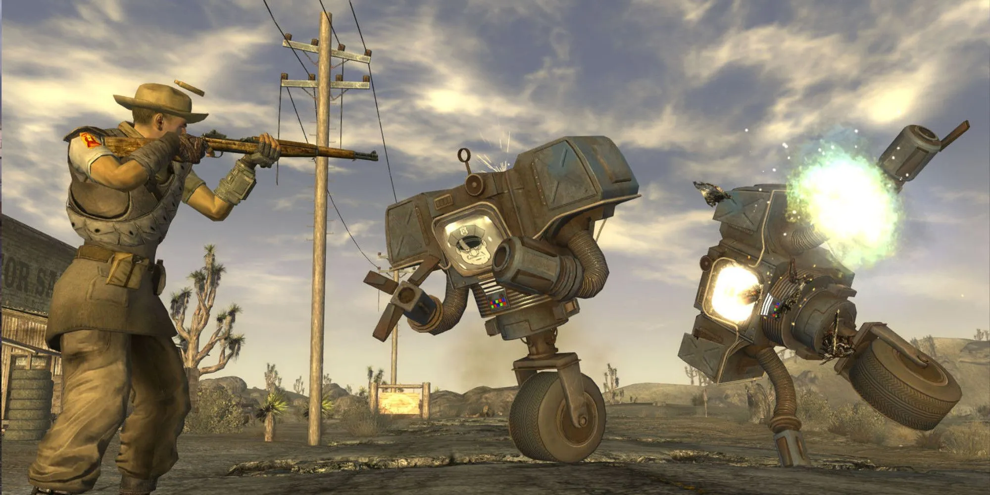 Nhân vật trong Fallout New Vegas chĩa vũ khí vào các cỗ máy trong một thế giới hậu tận thế