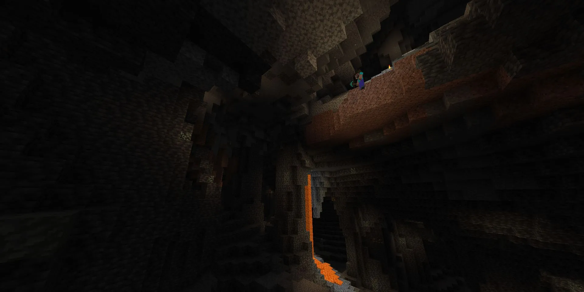 Steve đứng ở rìa vực nhìn xuống hang động sâu rộng trong Minecraft
