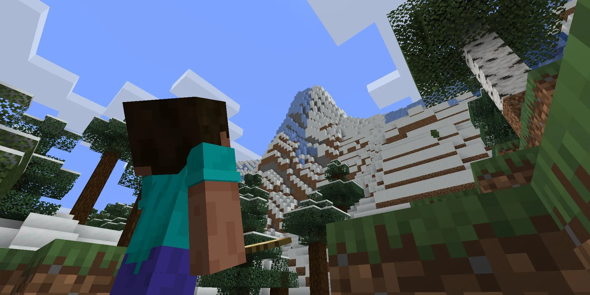 Steve nhìn lên vách núi cao trong Minecraft sau cập nhật Caves & Cliffs