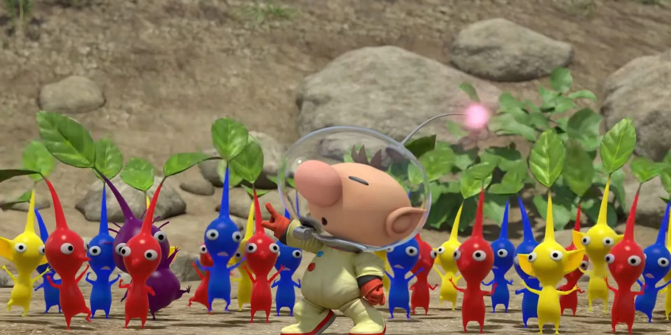 Thuyền trưởng Olimar đang chỉ huy một nhóm Pikmin đủ màu sắc đỏ, xanh, vàng và tím trong game Pikmin