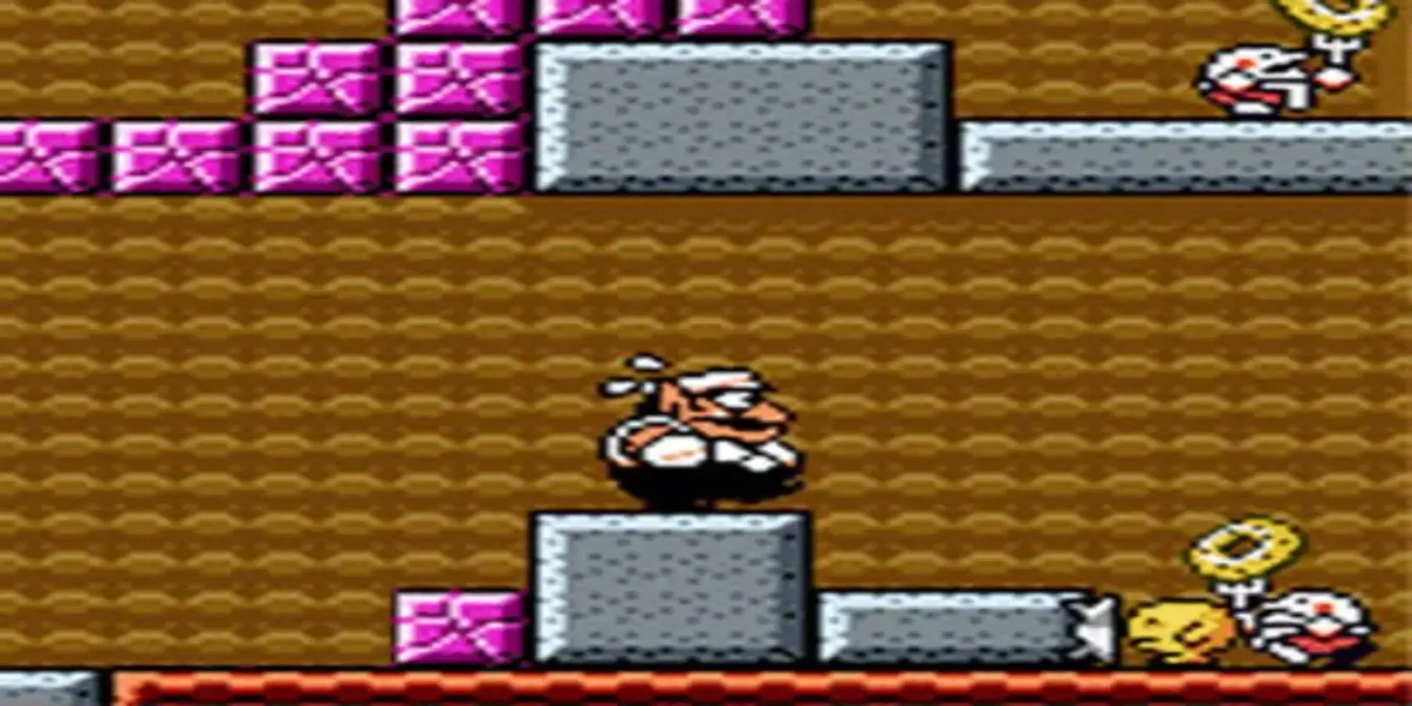 Wario với hình dạng bị đốt cháy đang chạy trong game Wario Land 3 trên GBC