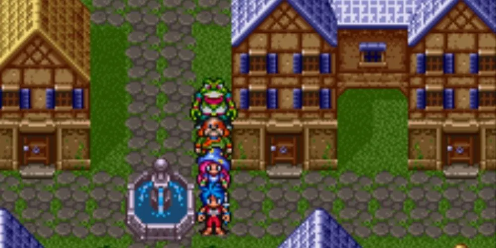 Hàng loạt nhân vật tập trung quanh một đài phun nước tại thị trấn trong game nhập vai Breath of Fire 2.